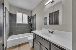 Bathroom with vanity, bathtub / shower combination, and light wood-style floors
