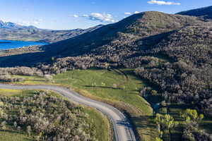 View of mountain backdrop featuring a nearby body of water