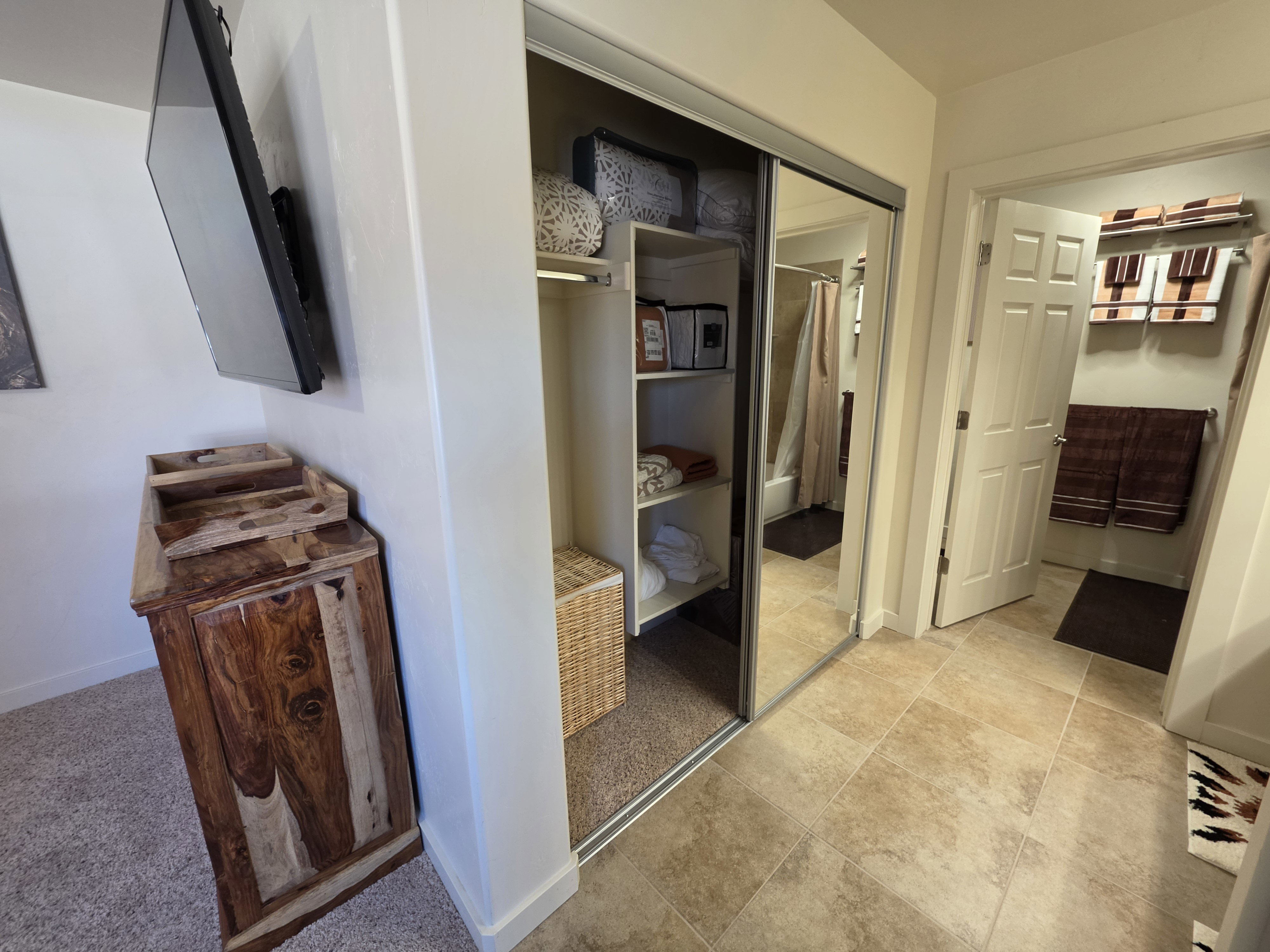 Mirrored sliding closet doors with built-in shelving offer organized storage