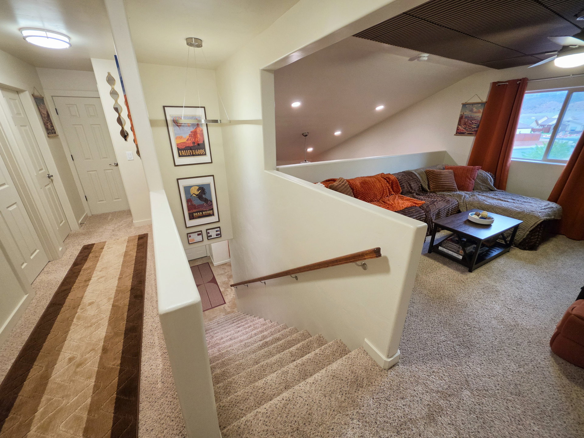 Stairs with carpet flooring and recessed lighting