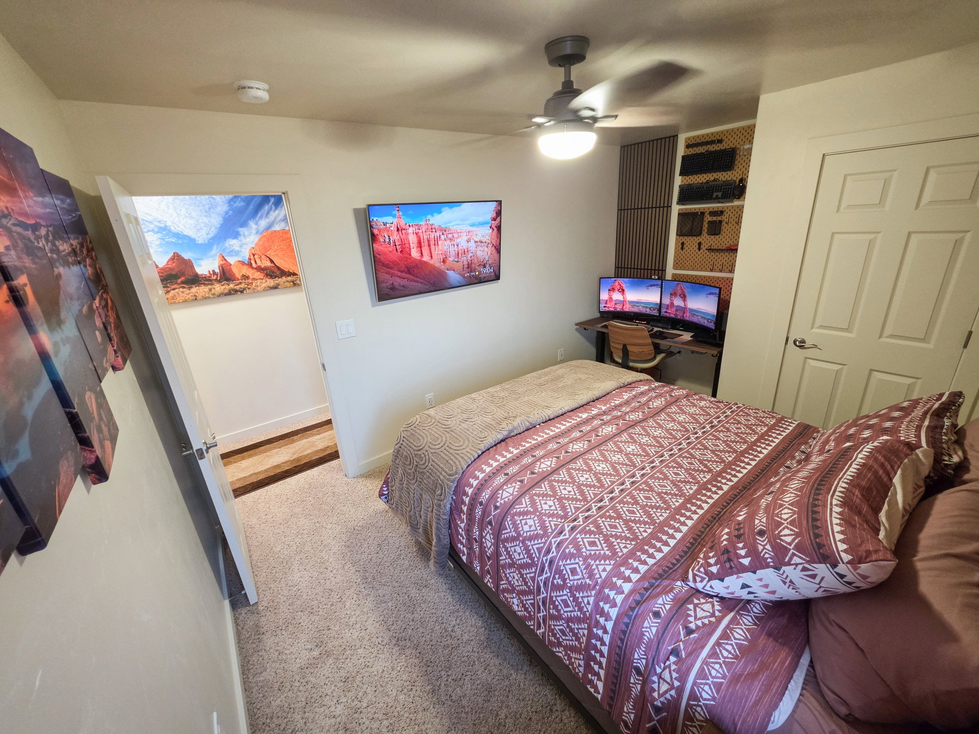 Carpeted room featuring a ceiling fan with integrated lighting, a paneled door, and neutral wall finishes