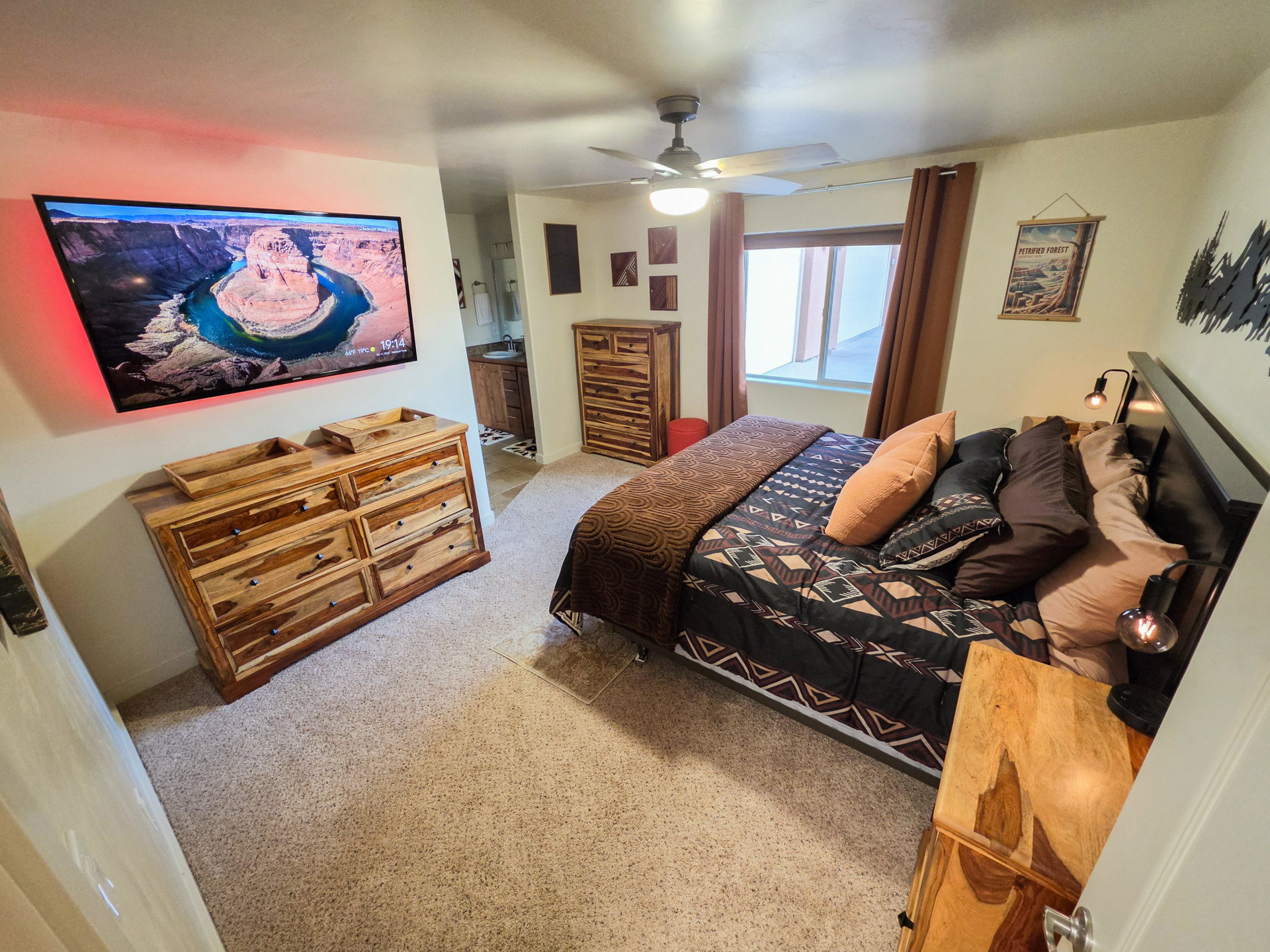 Bedroom featuring light colored carpet and a ceiling fan