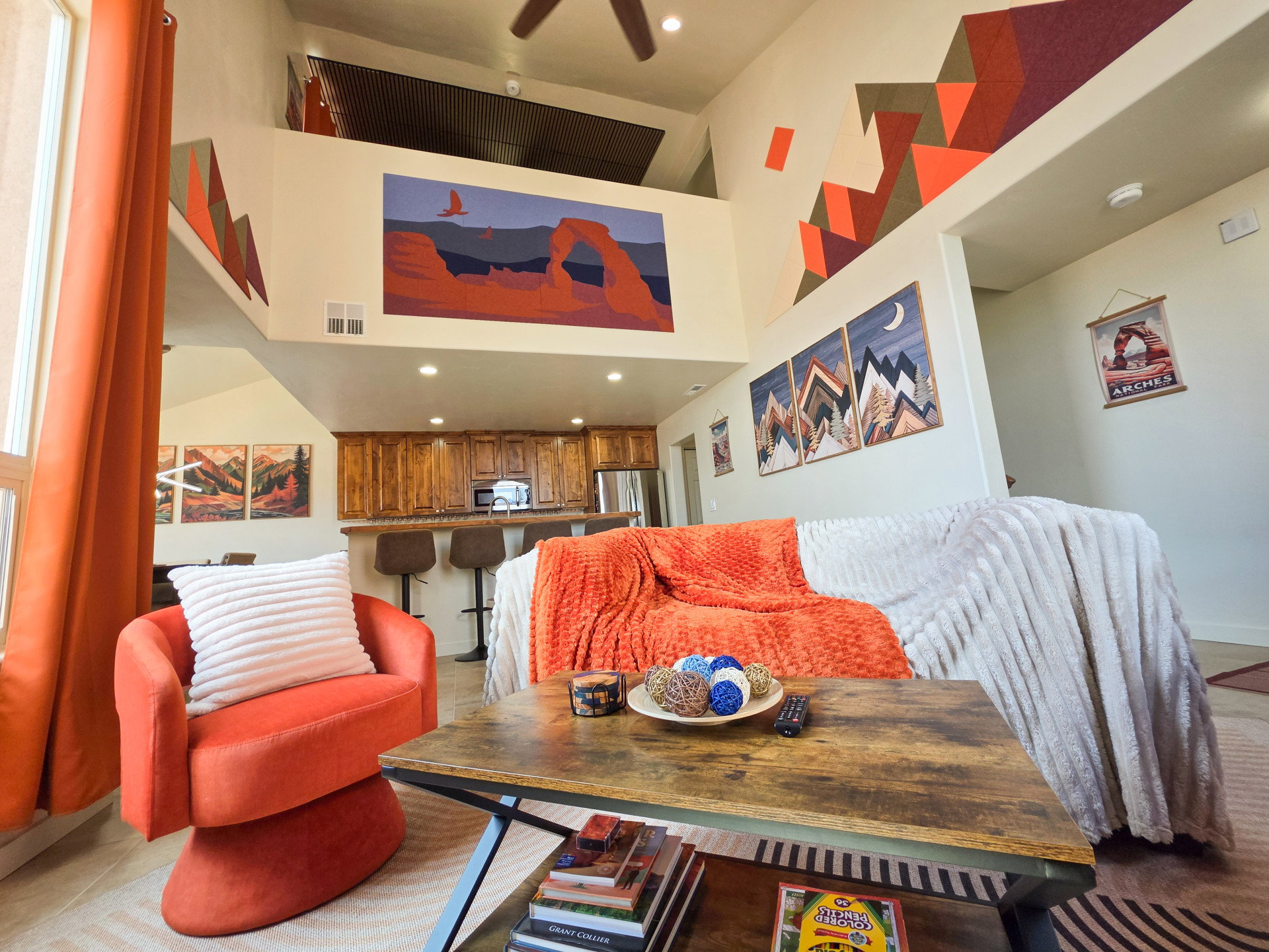 Living area featuring a high ceiling, recessed lighting, and ceiling fan