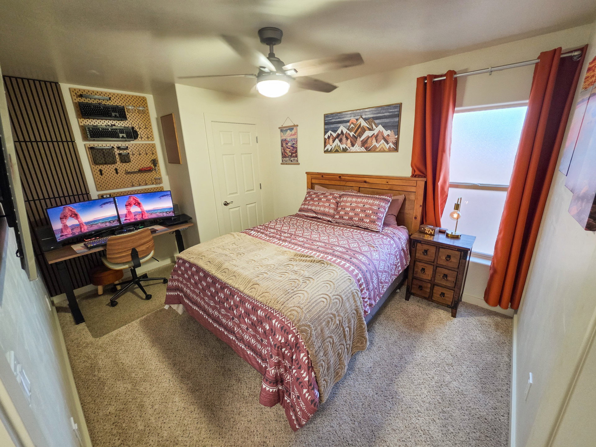 Bedroom featuring light colored carpet, an office area, and ceiling fan