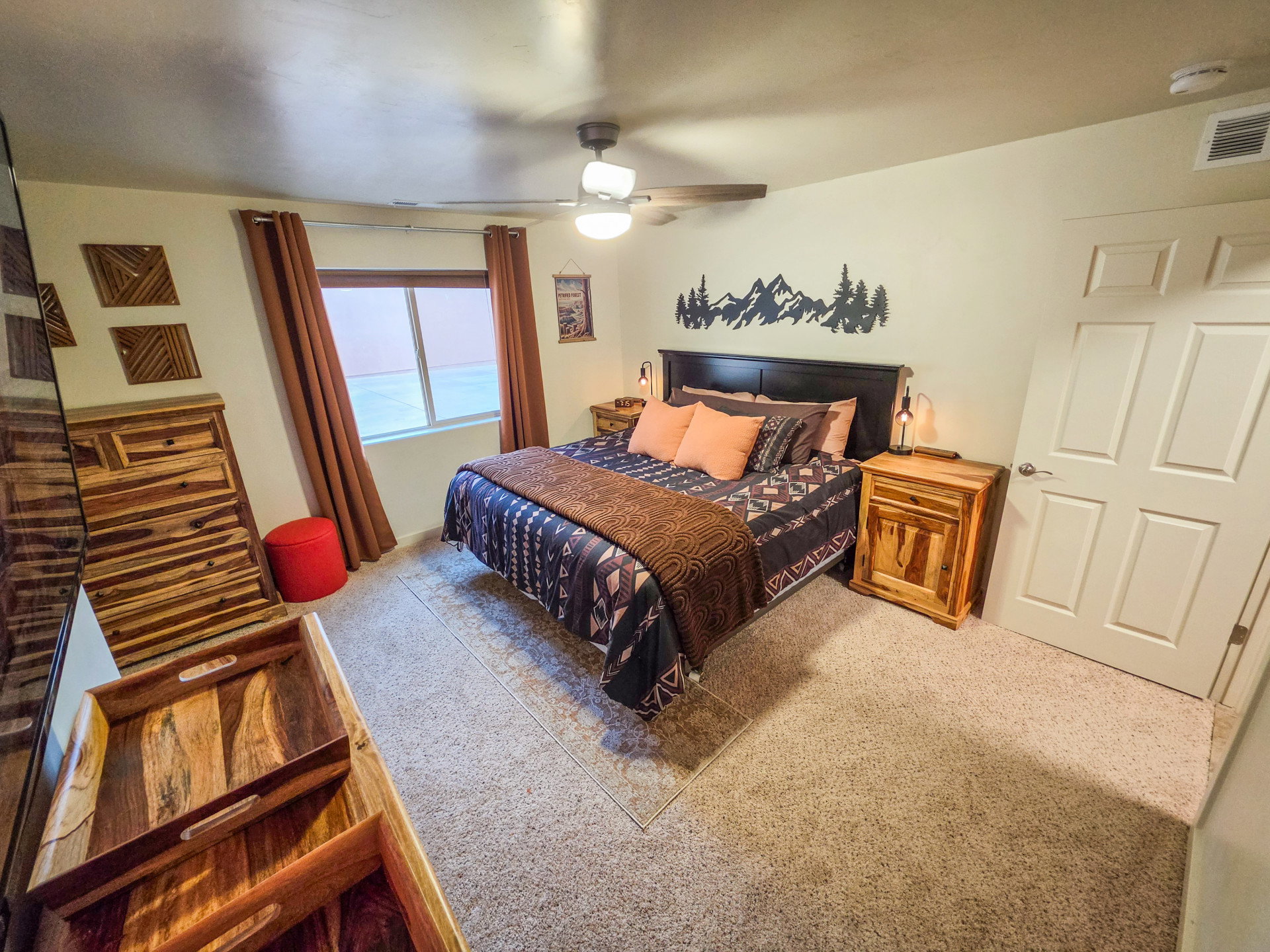 Carpeted bedroom featuring a ceiling fan
