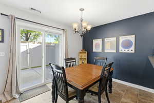 Dining room with hanging lights and baseboards