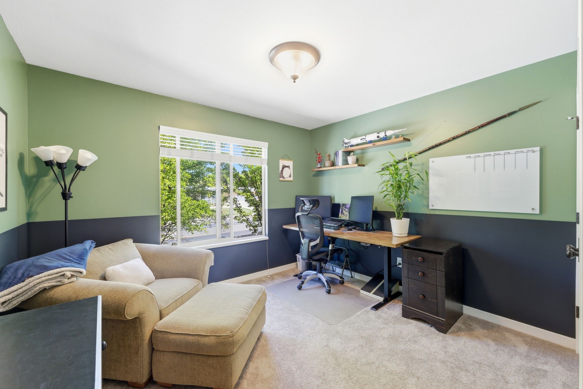 Office area featuring light carpet and baseboards