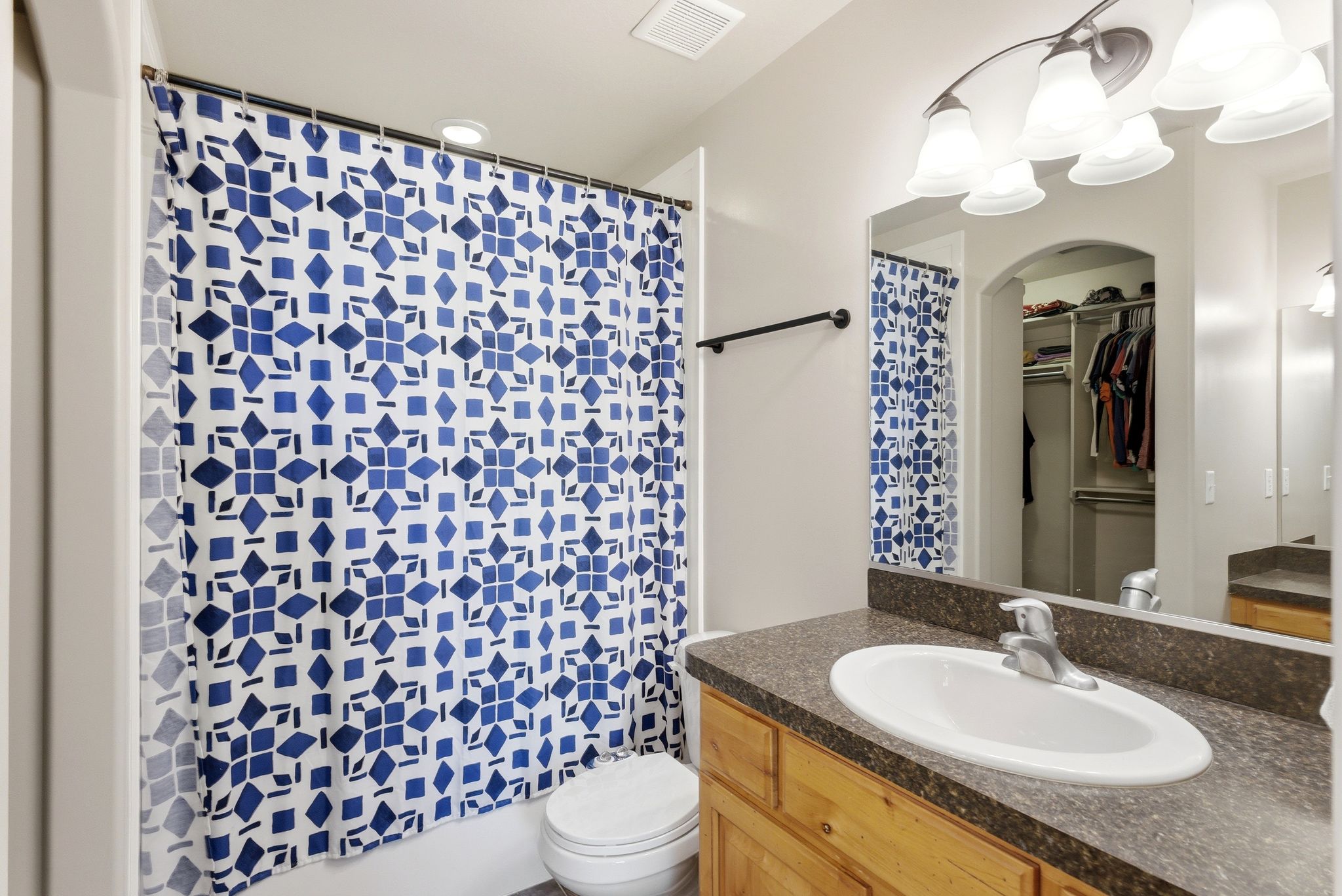 Bathroom with vanity and a spacious closet
