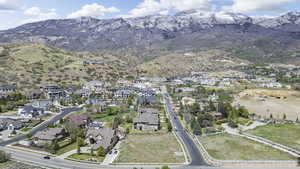 Aerial view of property's location featuring mountains and nearby suburban area