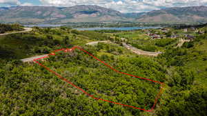 Aerial view of property's location with property boundaries highlighted and a water and mountain view