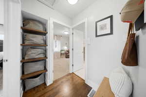 Hallway with dark wood-style floors and baseboards