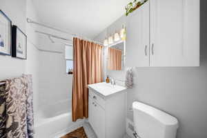 Full bathroom with vanity and shower / bathtub combination with curtain