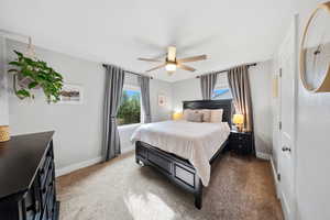 Bedroom featuring light carpet and a ceiling fan