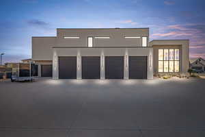 Contemporary home with stucco siding, concrete driveway, a patio area, and a garage
