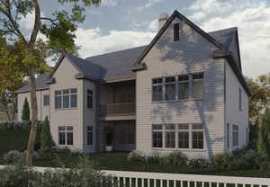 Rear view of house featuring a balcony, a chimney, and roof with shingles