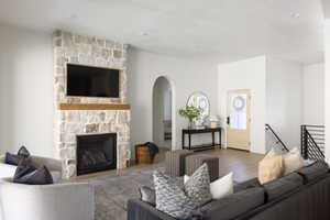 Stone-clad fireplace with a wood mantle