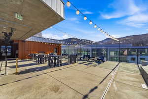 View of patio with a mountain view and outdoor dining area