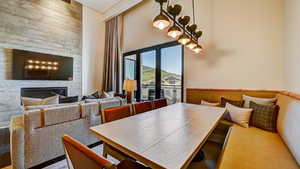 Dining room featuring a high ceiling and a large fireplace