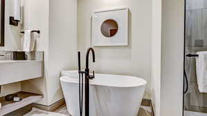 Bathroom featuring a freestanding bath and vanity