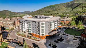 Aerial view of a mountainous background and apartment complex / building
