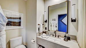 Half bath with vanity and backsplash