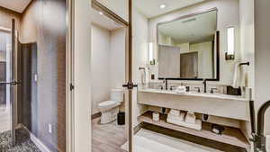 Bathroom with toilet and double vanity