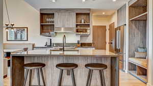 Kitchen featuring open shelves, dark stone countertops, stainless steel appliances, and recessed lighting