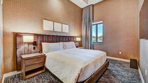 Bedroom featuring baseboards and wallpapered walls