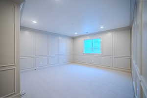 Spare room with a decorative wall, light colored carpet, and recessed lighting
