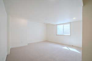 Spare room with light colored carpet and recessed lighting