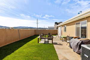 Fenced backyard with a patio area and a mountain view