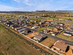 Aerial overview of property's location featuring nearby suburban area and mountains