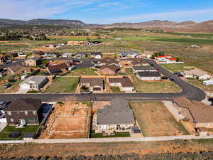 Aerial overview of property's location with nearby suburban area and a mountain backdrop