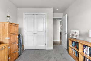 Bedroom featuring a closet and light carpet