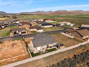 Aerial view of property's location featuring nearby suburban area and a mountain backdrop