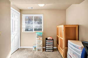 Misc room featuring light colored carpet and baseboards