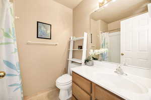 Bathroom with vanity and a shower with shower curtain