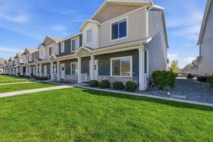 View of front of house with a porch, a front lawn, and a residential view