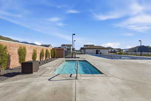 Community pool with a residential view and a patio area