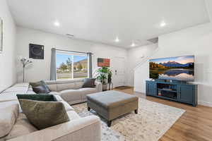 Living area featuring wood finished floors and recessed lighting
