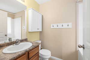 Full bathroom with toilet and vanity