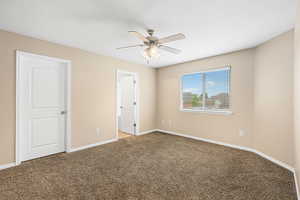 Unfurnished bedroom with carpet floors and a ceiling fan