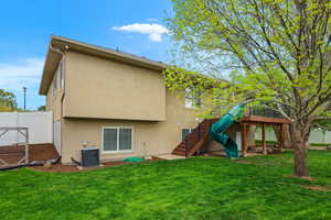 Back of house featuring stucco siding and stairs