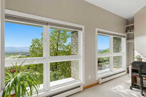 Office featuring a baseboard heating unit and light colored carpet