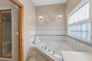 Bathroom with a jetted tub and a stall shower