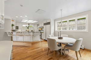 Dining space with light wood-style flooring and baseboard heating