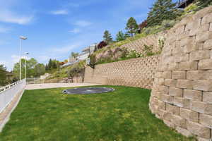 Fenced backyard featuring basketball hoop