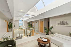 Carpeted living area featuring a baseboard radiator and recessed lighting