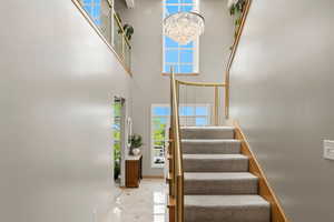 Stairs with plenty of natural light and a high ceiling