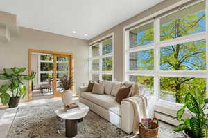 Living area featuring baseboard heating and recessed lighting
